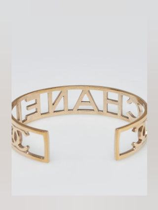 Chanel Goldtone Brushed Metal Logo Cuff Bracelet
