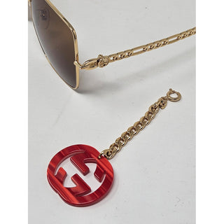 Eye catching Gucci gold-tone chain GG logo charm sunglasses